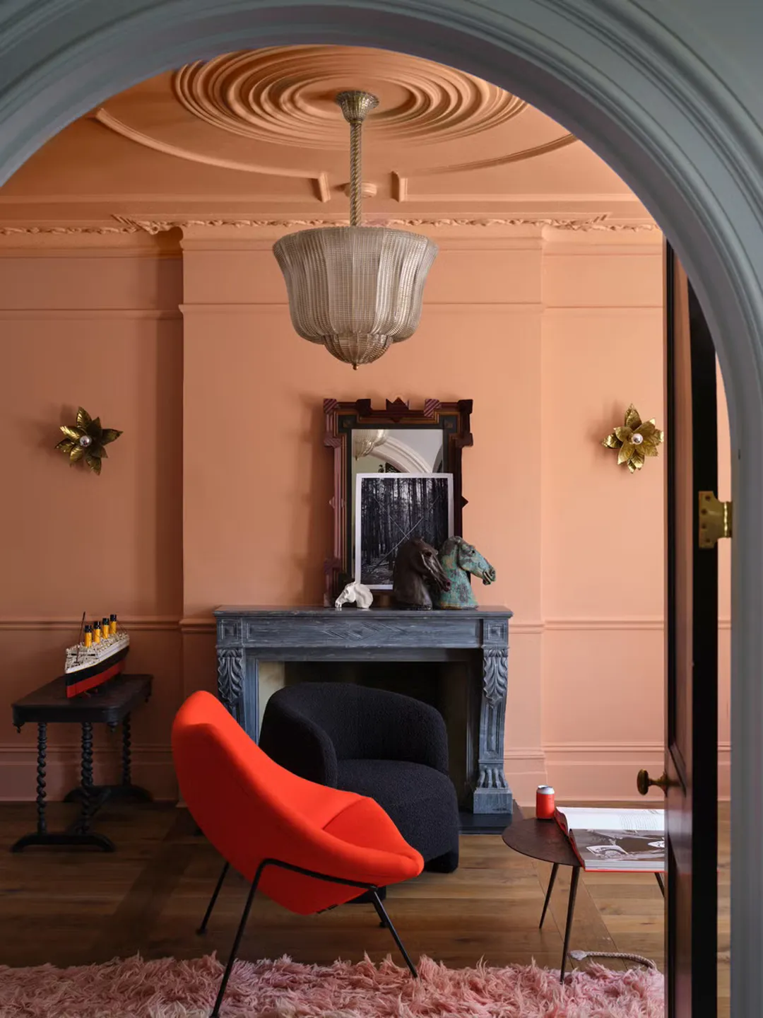 A living room painted Farrow & Ball Etruscan Red, a faded terracotta color
